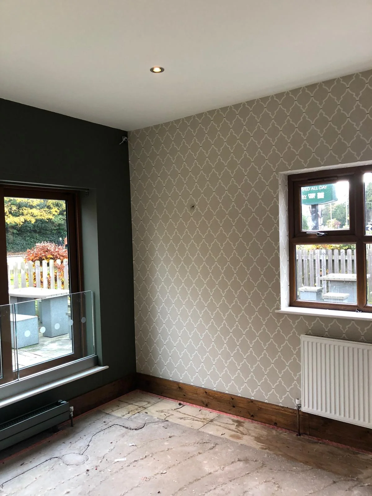 Geometric trellis feature wallpaper hung in living room
