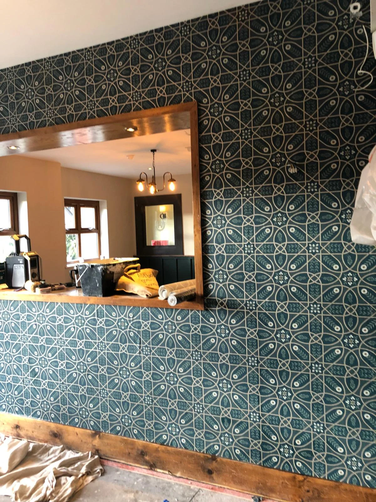 Bold teal decorative wallpaper with intricate pattern — residential project